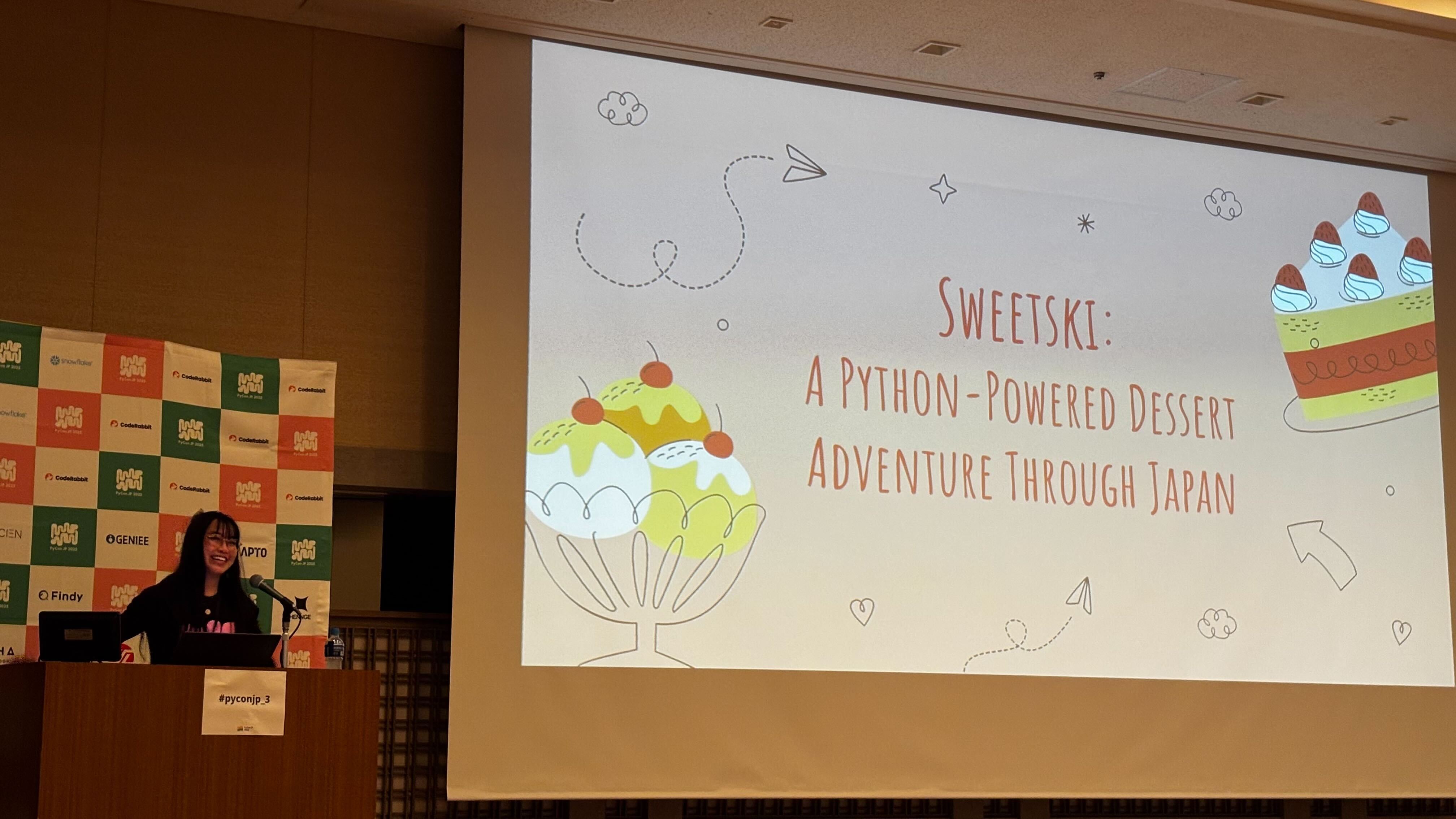 Photo of Diane on stage giving a talk.